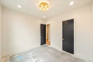 Unfurnished bedroom featuring recessed lighting and concrete floors