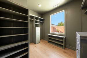 Walk in closet featuring light wood-type flooring
