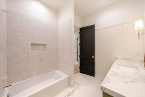 Bathroom featuring vanity and shower / tub combination