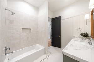 Bathroom with double vanity and shower / washtub combination
