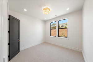 Empty room featuring carpet flooring and recessed lighting