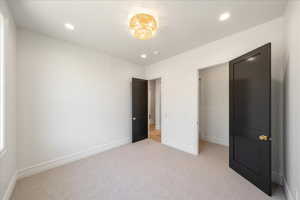 Unfurnished bedroom with carpet and recessed lighting