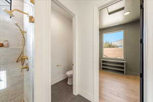 Bathroom with a tile shower and light tile patterned floors