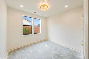 Unfurnished room with recessed lighting and concrete floors