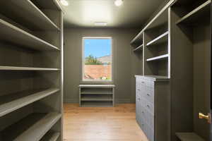 Walk in closet featuring light wood-style floors