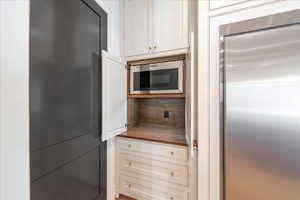 Kitchen with white cabinets, stainless steel appliances, and butcher block countertops