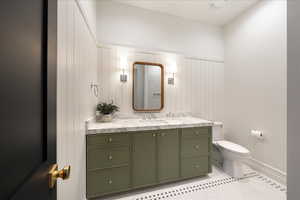 Bathroom featuring vanity and toilet