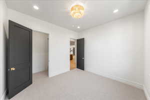 Unfurnished bedroom featuring light colored carpet and recessed lighting