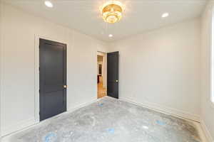 Unfurnished bedroom featuring recessed lighting and concrete floors