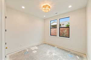 Spare room with baseboards and recessed lighting