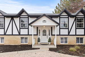 View of front of home with stucco siding and brick siding