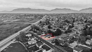 Aerial view of property and surrounding area with nearby suburban area and property parcel outlined