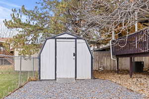 View of shed with a fenced backyard