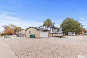 View of front of house featuring concrete driveway, brick siding, and a garage
