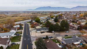 Aerial view of property's location featuring nearby suburban area and a mountainous background