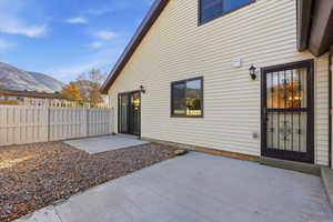 Rear view of house featuring a patio area and a mountain view