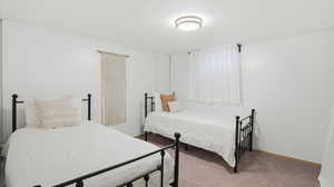 Bedroom featuring carpet flooring and baseboards