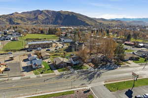 Aerial overview of property's location featuring a mountainous background and nearby suburban area