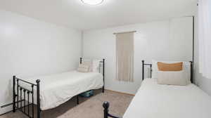 Bedroom featuring carpet flooring and baseboards