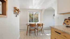 Dining space featuring recessed lighting, light wood finished floors, and a baseboard heating unit