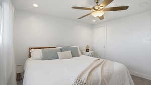 Carpeted bedroom featuring recessed lighting and a ceiling fan