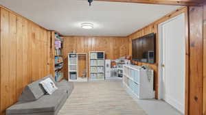 Sitting room featuring wooden walls