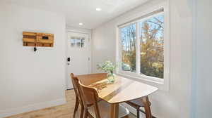 Dining space with light wood-style flooring and recessed lighting
