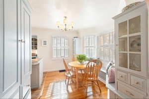 Dining area with light wood-style floors and a chandelier