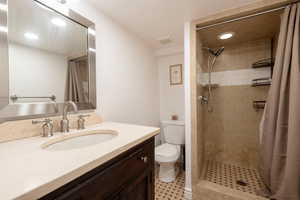 Bathroom featuring a shower stall, vanity, and recessed lighting