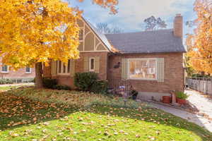 View of front of house with brick siding and a chimney