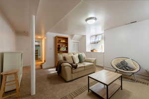 Living area with light colored carpet and baseboards