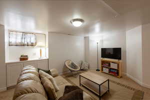 Living room featuring light carpet and baseboards
