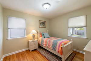 Bedroom featuring light wood-style flooring and multiple windows