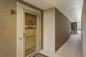 Property entrance featuring stucco siding