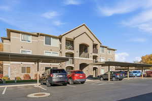 View of building exterior with covered parking