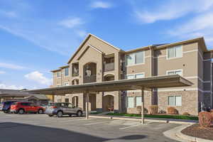 View of building exterior with covered parking