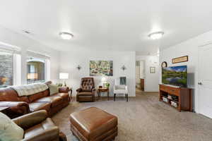 Carpeted living area with baseboards