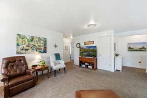 Living room with light carpet and baseboards