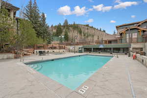 Community pool featuring a patio area and a mountain view