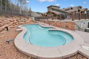 Community pool with a patio