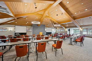 Dining room featuring carpet floors, healthy amount of natural light, a wooden ceiling with exposed beams, and recessed lighting