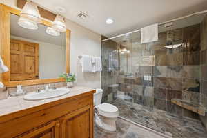Bathroom with vanity, a shower stall, and recessed lighting