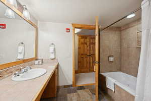 Bathroom featuring vanity and tiled shower / bath combo