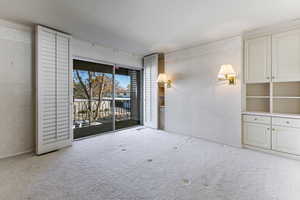 Spacious primary suite featuring plantation shutters ,balcony, storage