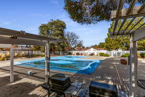 Community pool featuring a pergola, a patio, a fenced backyard, and a gazebo