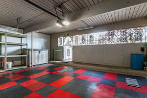 Garage with a garage door opener and door to the outside