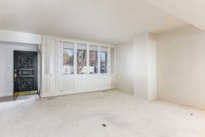 Carpeted empty room with baseboards