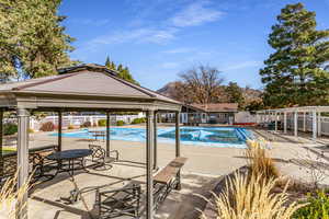 Community pool featuring a patio and a gazebo