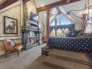 Bedroom featuring carpet and a fireplace