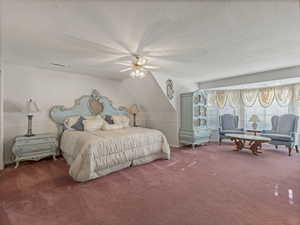Bedroom featuring carpet, a textured ceiling, a ceiling fan, and lofted ceiling
